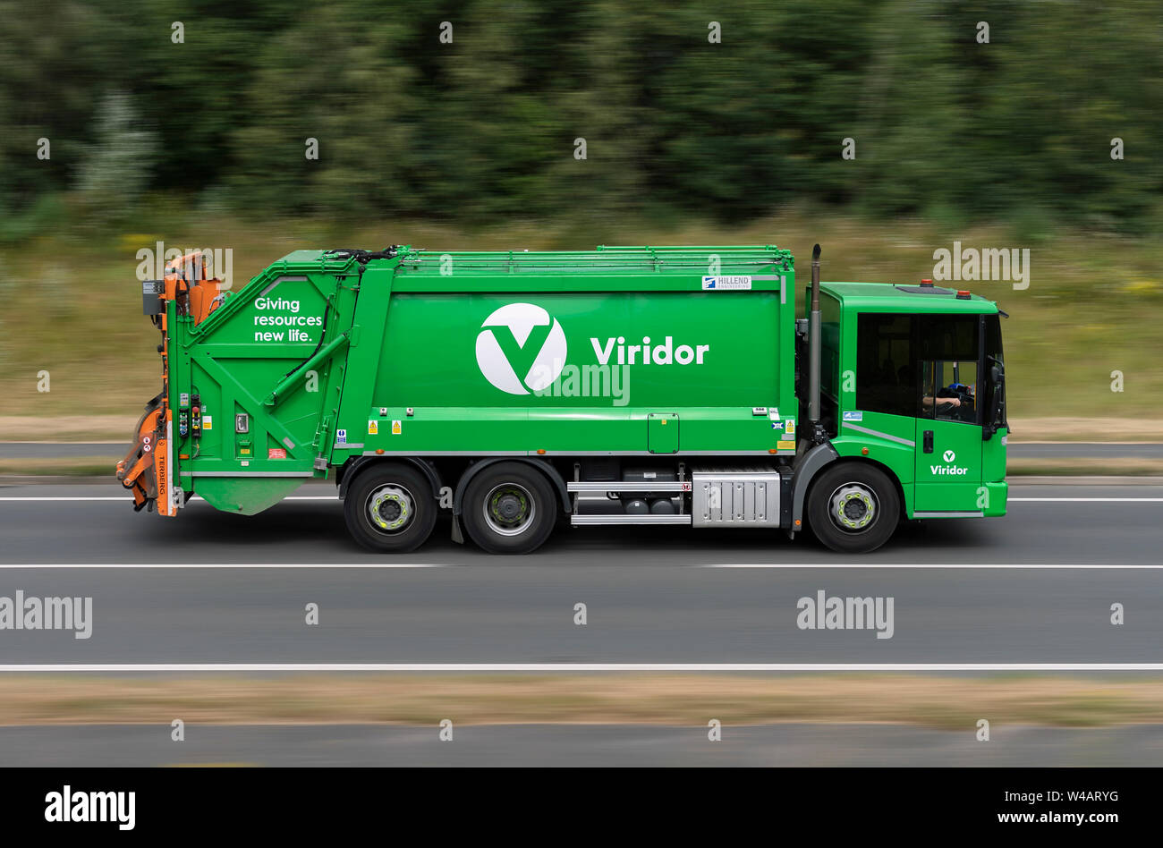 A Viridor waste disposal and collection lorry travels along the A556 road in Alderley Edge, Cheshire, UK. Stock Photo