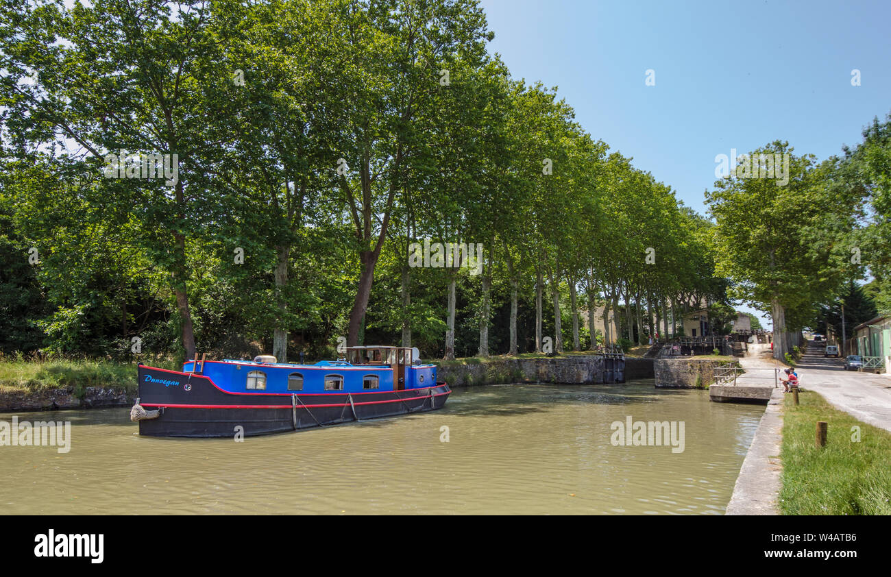 Canal du Midi France with a canal boat leaving a lock Stock Photo