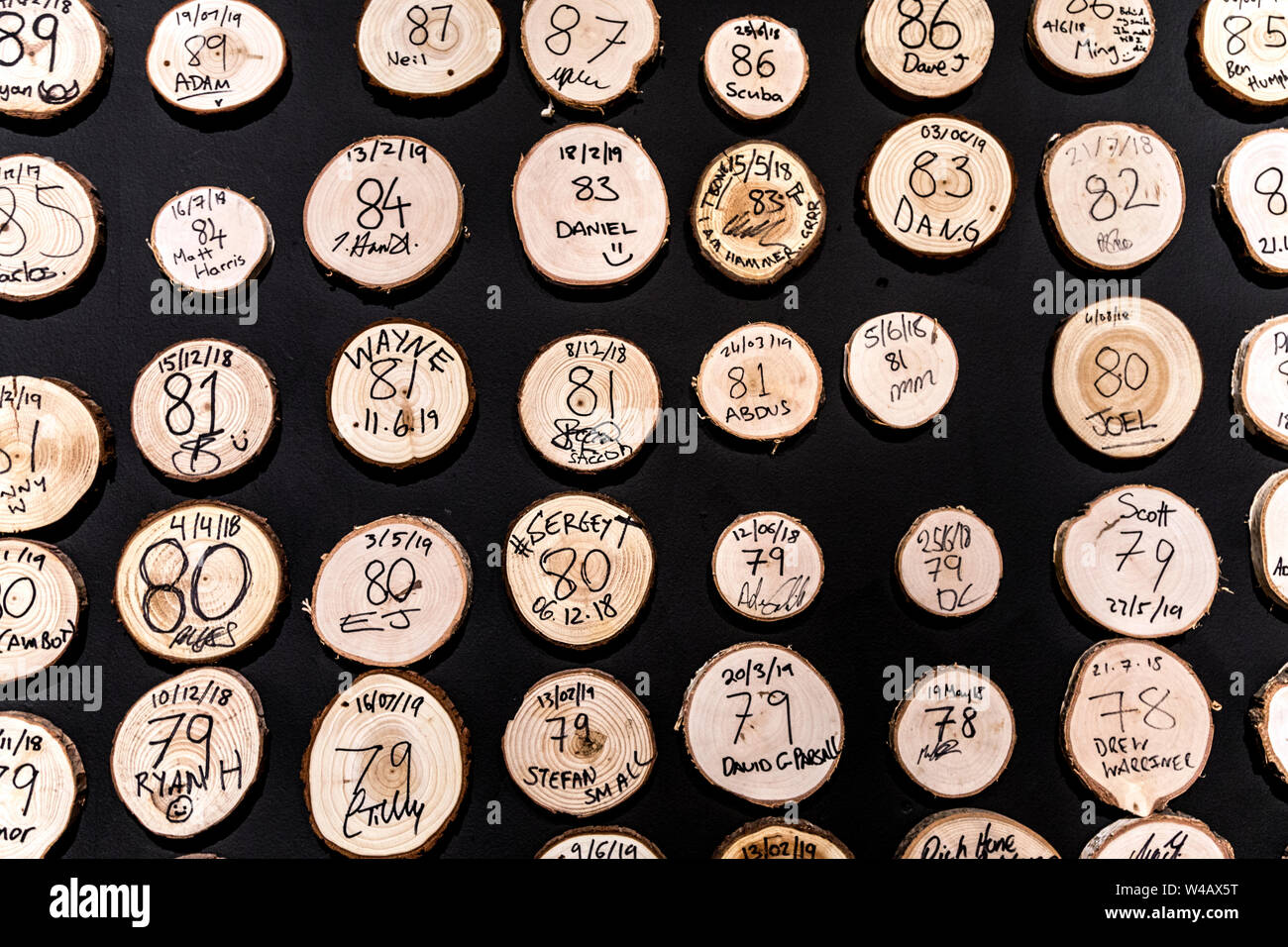 Tree slices with high scores on the wall at Whistle Punks Urban Axe Throwing, London, UK Stock Photo