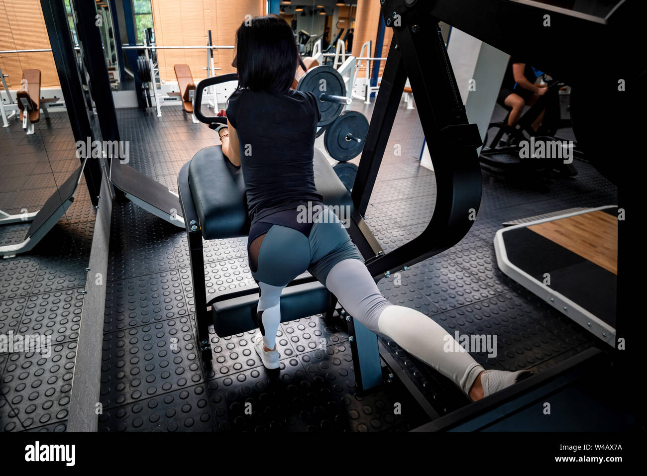Back view young woman does rear kick in modern gym Stock Photo Alamy
