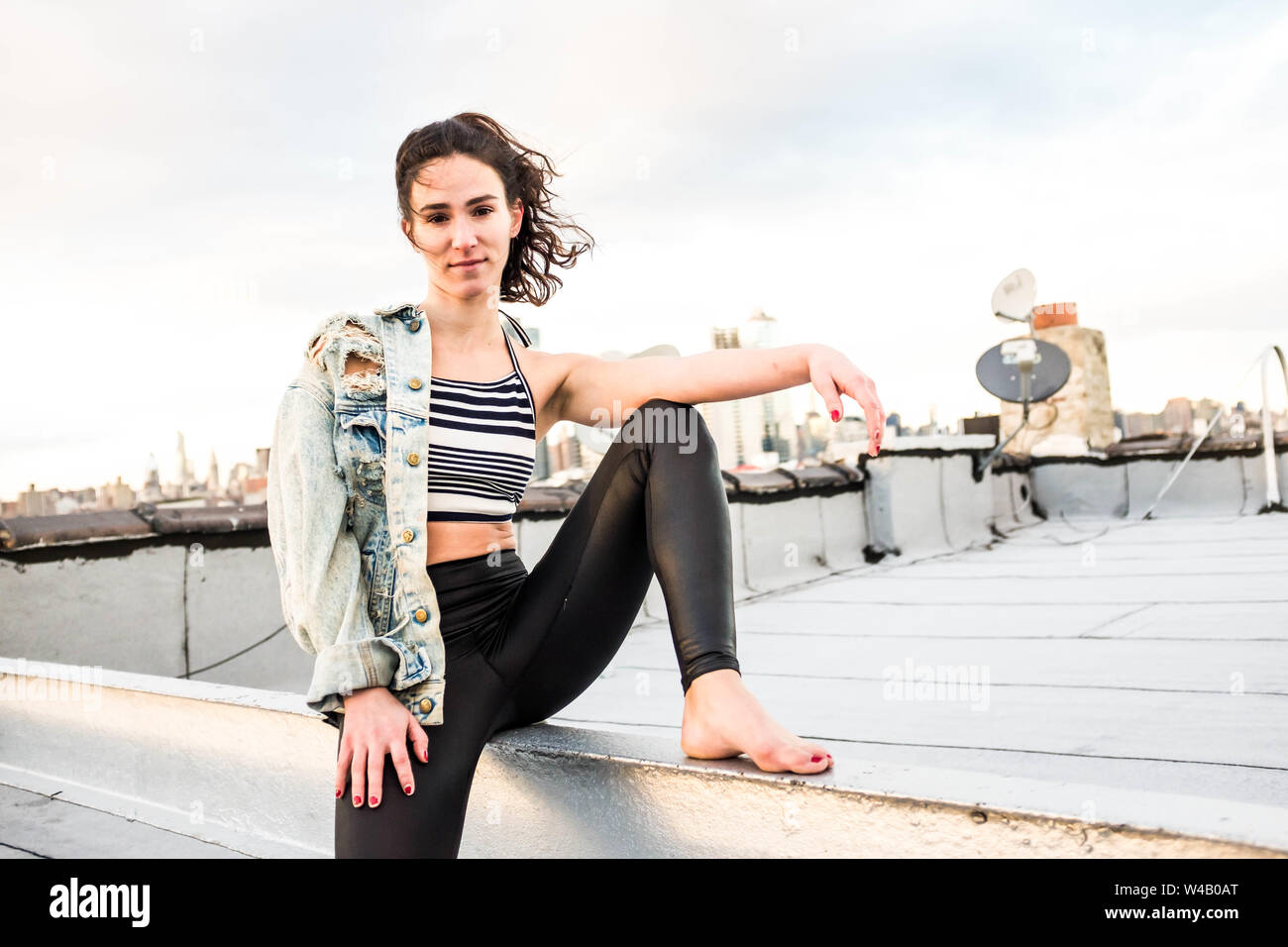 Young woman poses on Brooklyn rooftop Stock Photo