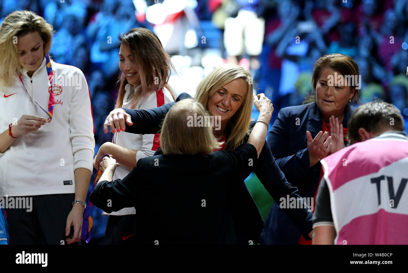 England coach Tracey Neville (centre) is presented with a bronze medal ...