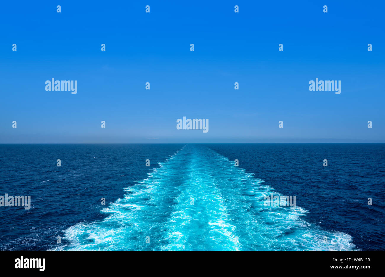 Boat wake ferry cruise wash foam in blue ocean sea Stock Photo
