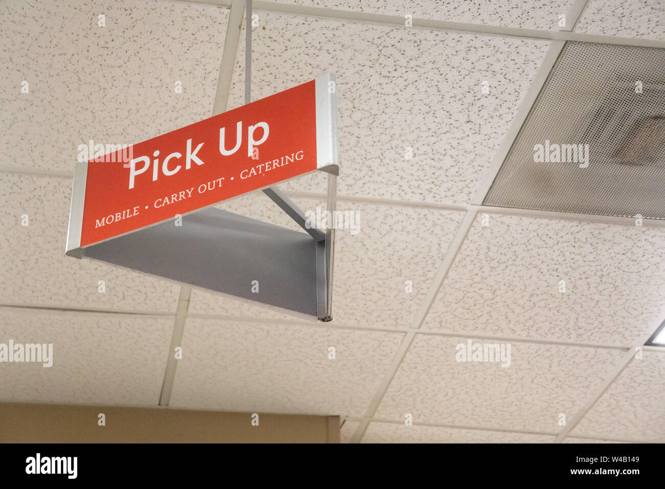 Atlanta, GA - July 26th 2019: Red pick up carry out sign on tile ceiling for mobile app orders at Chick-Fil-A. Jump the line and order ahead. Stock Photo