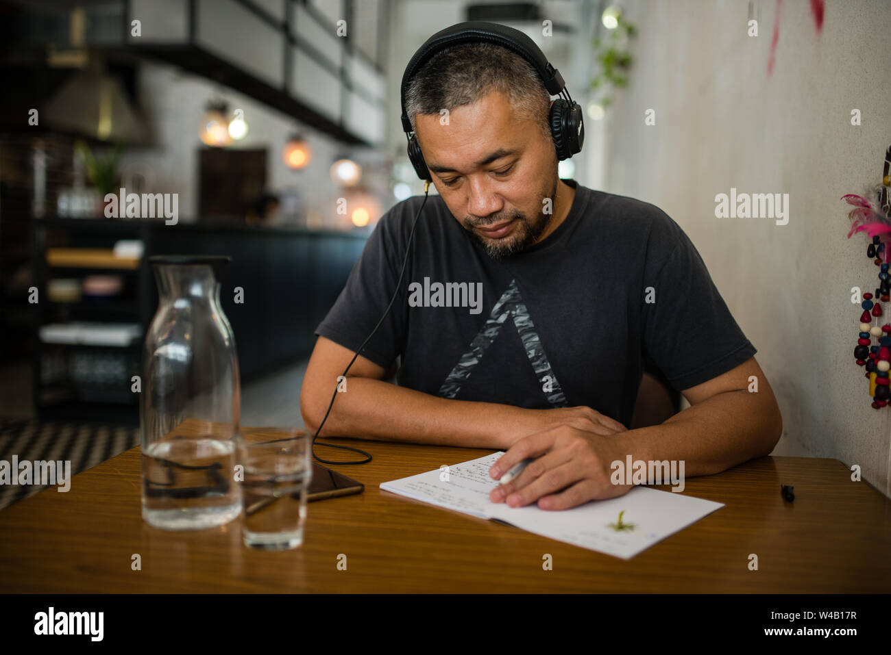 Asian man listening music on headphones Stock Photo