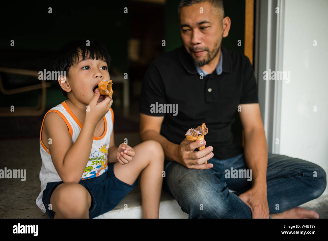 Boy and father eating ice cream Stock Photo