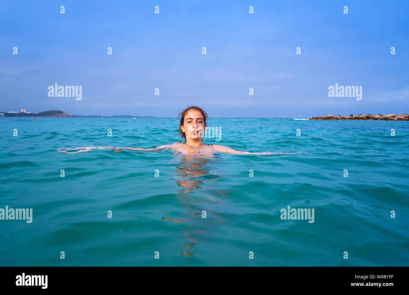 Young woman girl bath in the Ibiza beach of Santa Eulalia at Balearic Islands Stock Photo