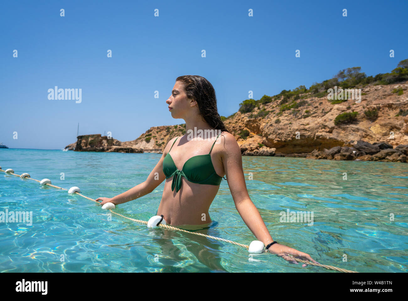 Ibiza bikini girl relaxed in clear water beach of Balearic Islands Stock Photo
