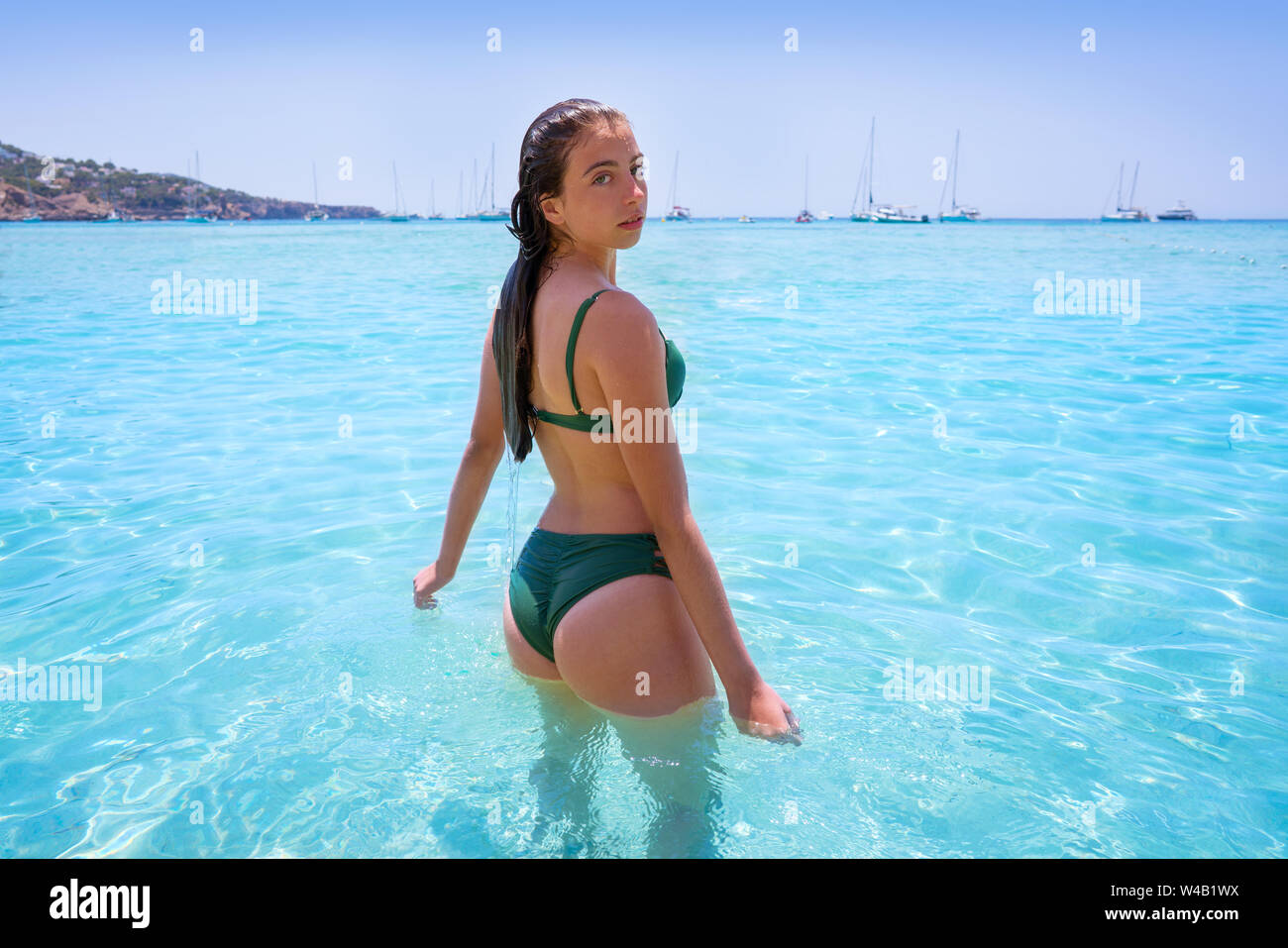 Ibiza bikini girl relaxed in clear water beach of Balearic Islands Stock Photo