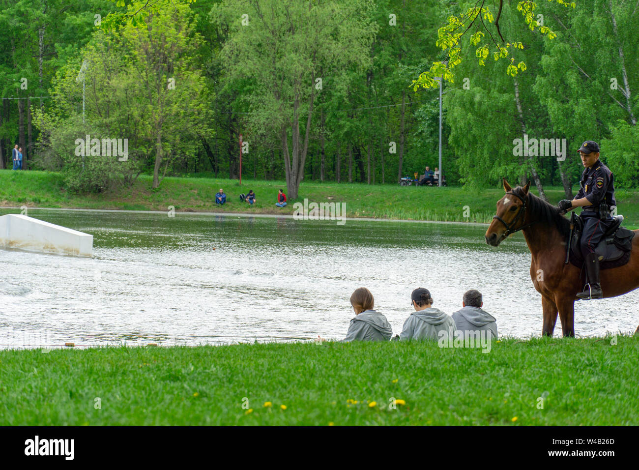 MOSCOW, RUSSIA - JUNE 12, 2019. Mounted police patrolling and controlling young people in the Park Kolomenskoye Stock Photo