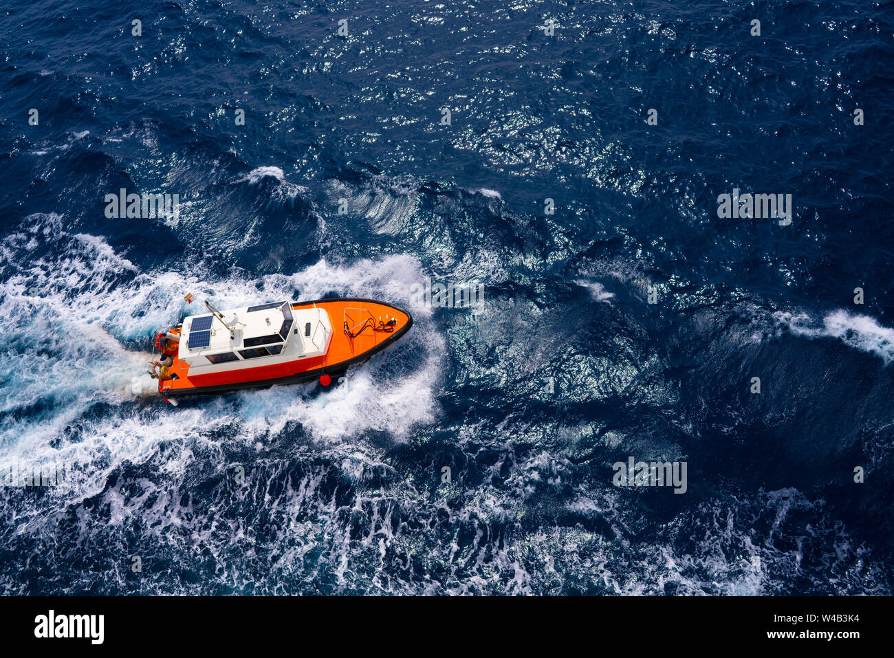 Pilots boat aerial view sailing in blue ocean sea with foam wake Stock Photo