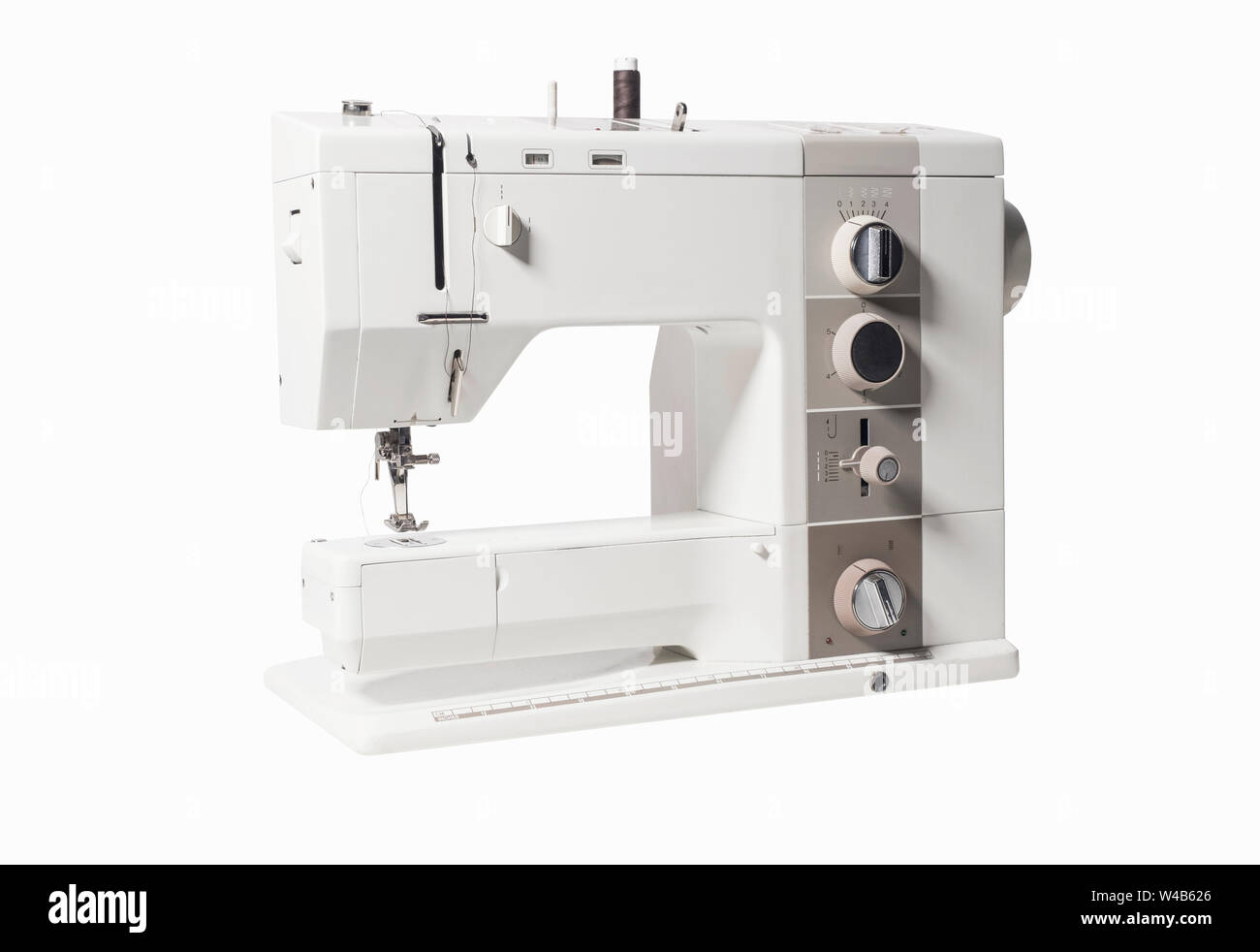 Retro sewing machine isolated on white background Stock Photo - Alamy