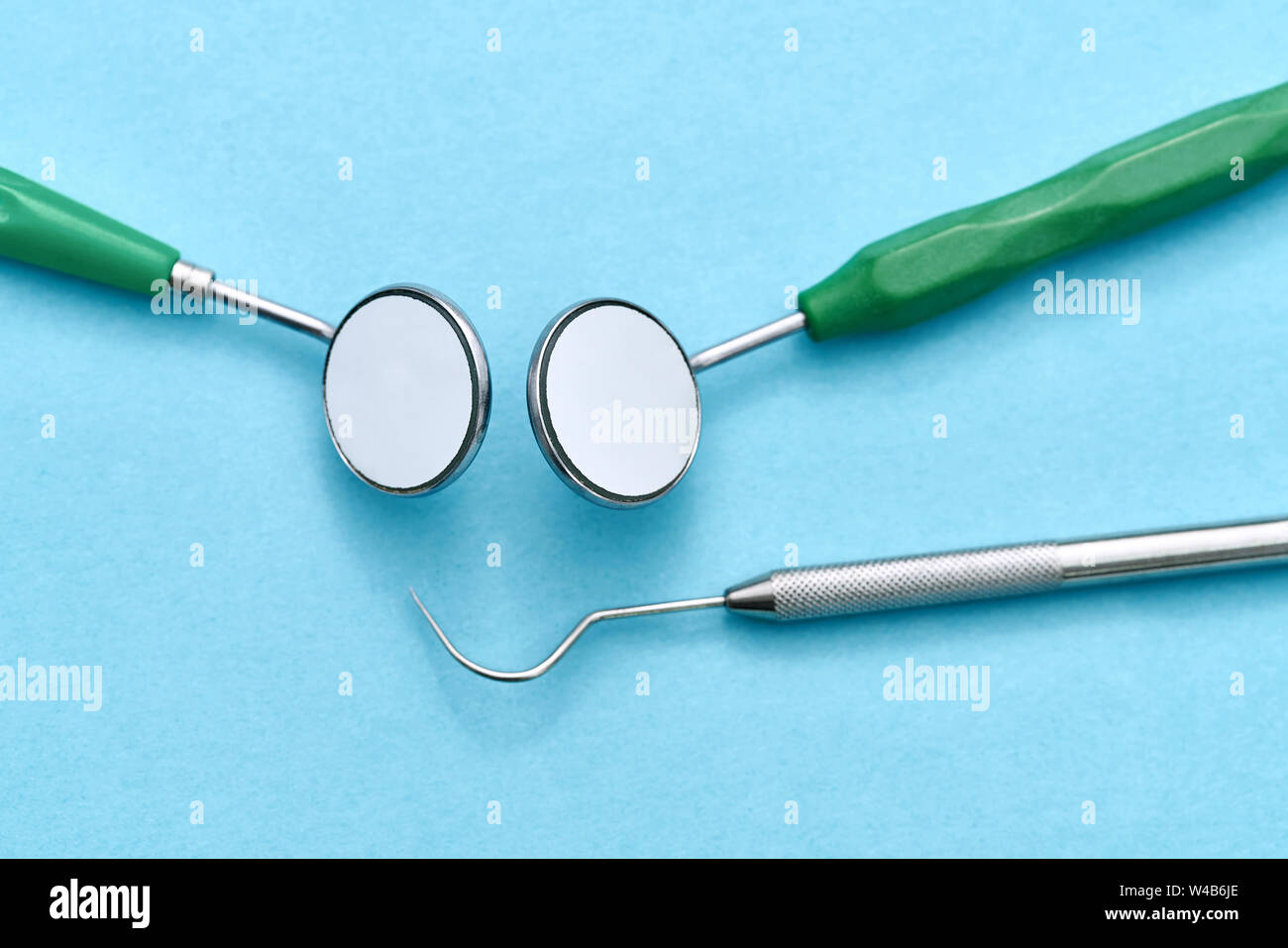 Kit of dental instruments lying on blue surface Stock Photo - Alamy