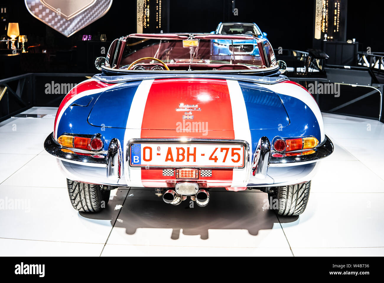 Brussels, Belgium, Jan 2019: vintage Jaguar E Type 1967 glossy and shiny old classic retro auto at Brussels Motor Show, Dream Cars, Great Britain flag Stock Photo