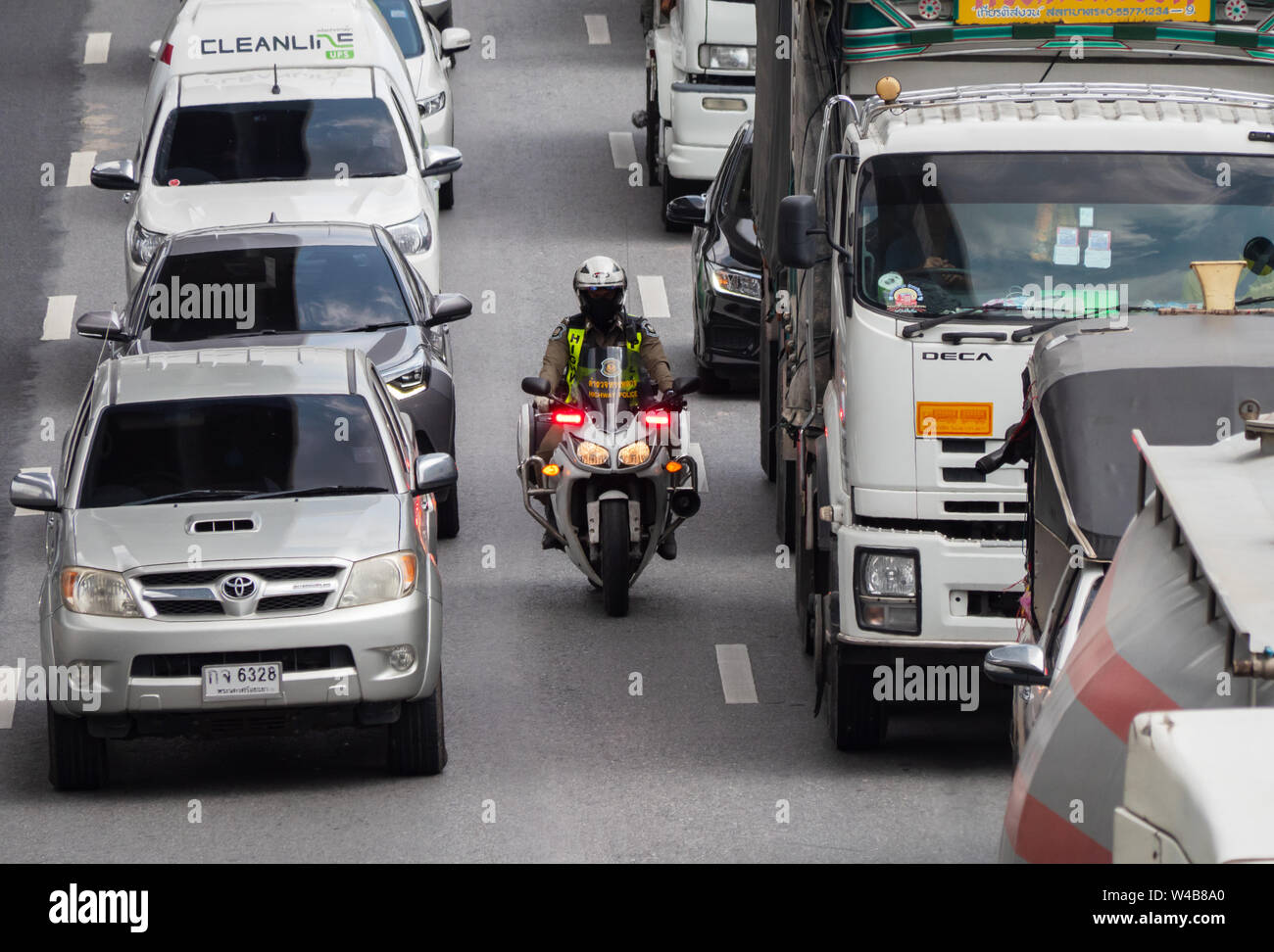 Bangkok, Thailand - May 28, 2018: Police motorbike manouvering through a traffic jam on Kanchana Phisek Road, the ring road around Bangkok, at Talat B Stock Photo