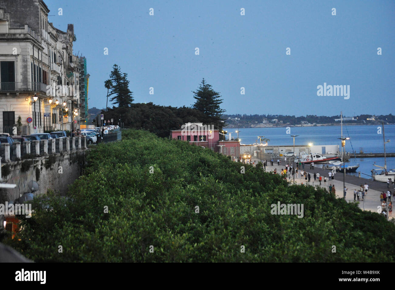 The waterfront comes alive at dusk as lights come on in Ortigia
