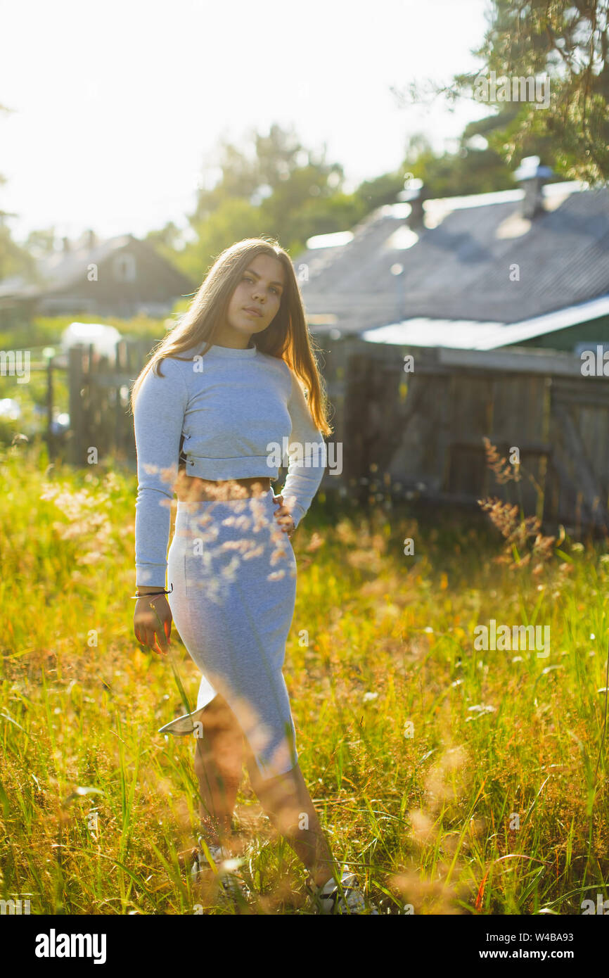 Young beautiful teenage girl posing outdoors in the village. Stock Photo