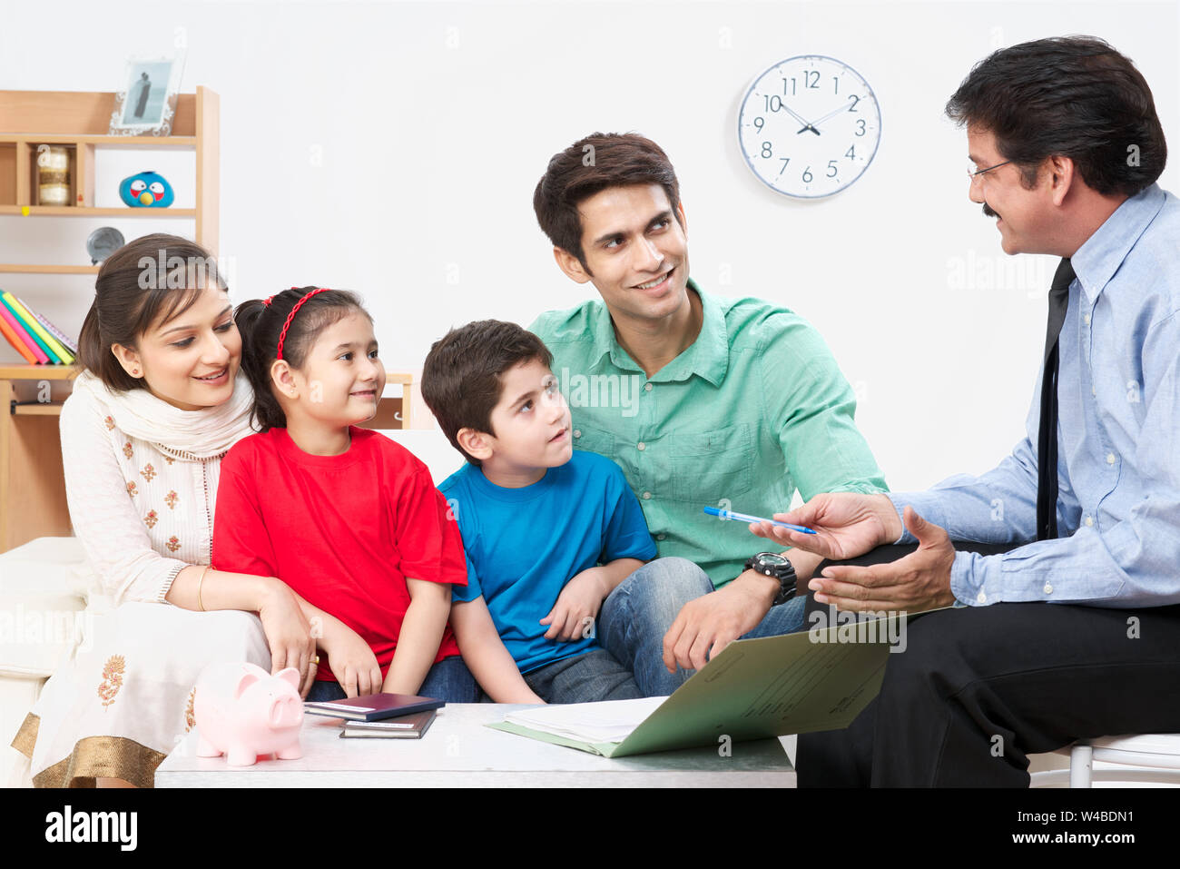 Executive explaining insurance plan to a family Stock Photo