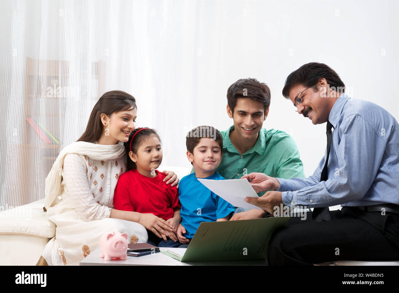 Executive explaining insurance plan to a family Stock Photo