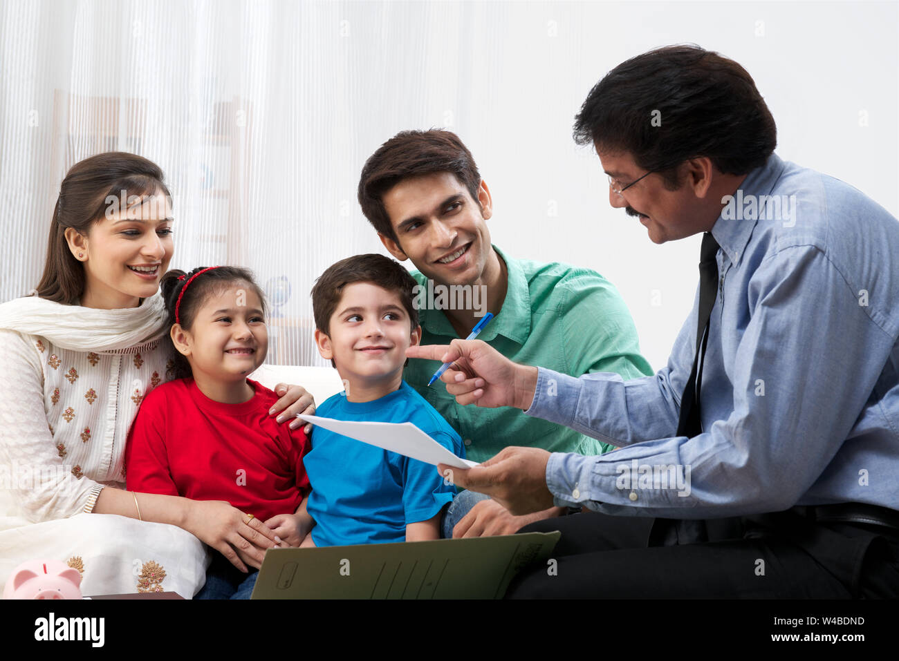 Executive explaining insurance plan to a family Stock Photo