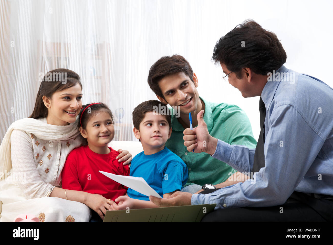 Executive explaining insurance plan to a family Stock Photo