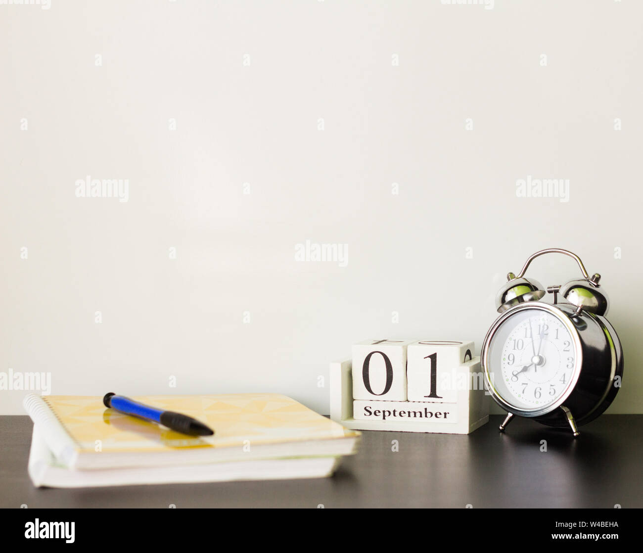 September 1 on a wooden calendar next to the alarm clock,the concept of the beginning of the school year Stock Photo