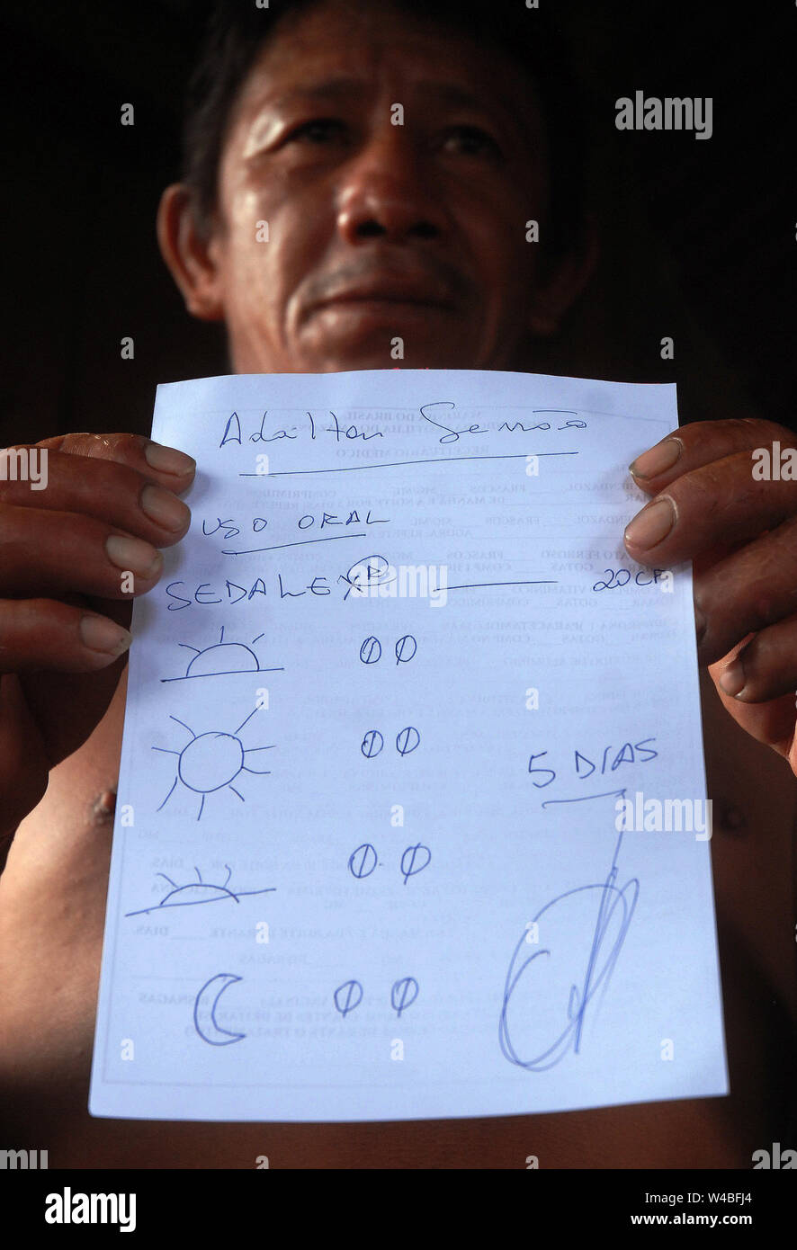 Illiterate riverbank holding prescription in the city of Itacoatiara in the state of Amazonas. Stock Photo