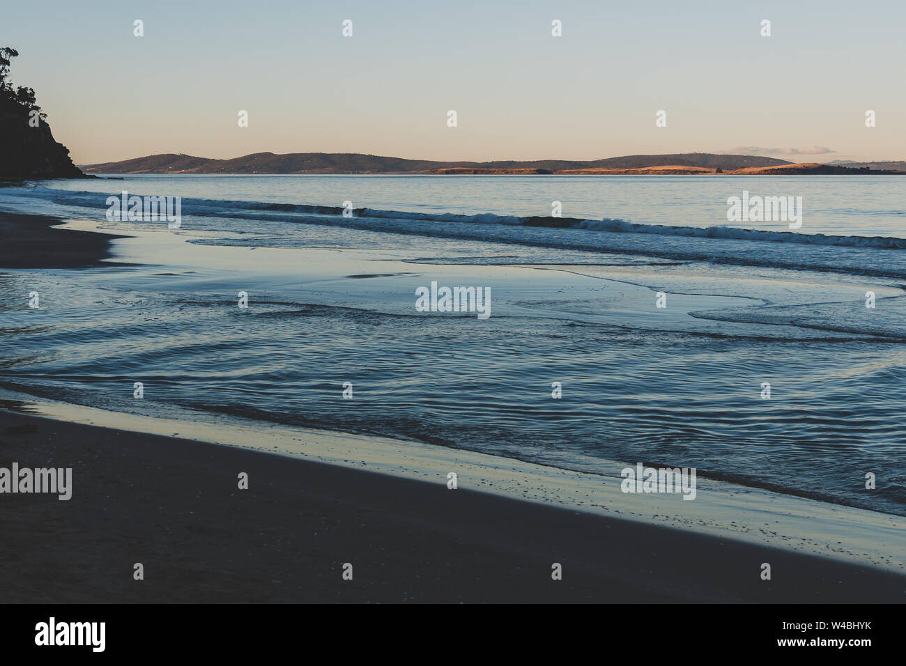 view of the water on a Tasmanian beach in South Hobart at dusk Stock Photo