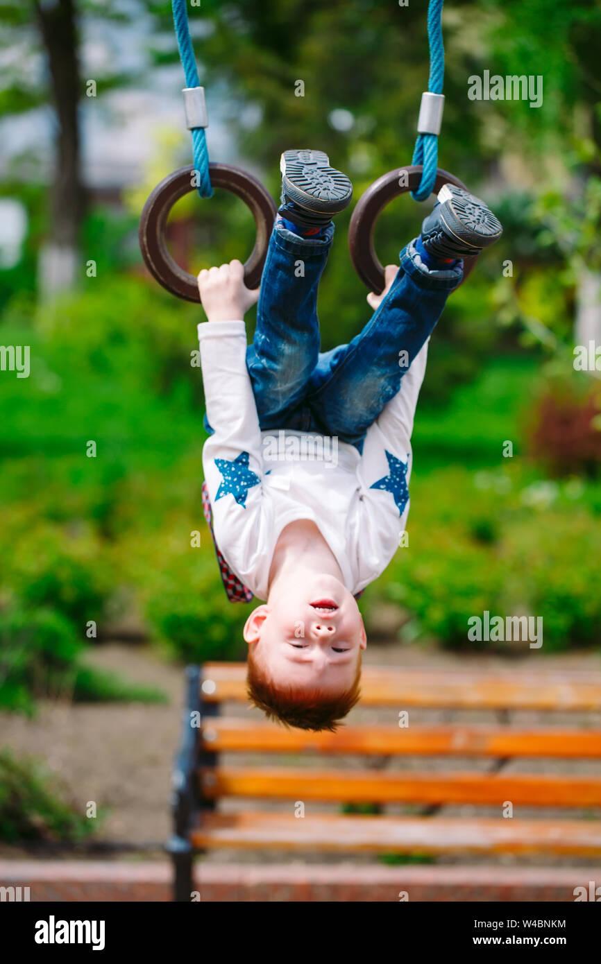 Little boy playing on the playground outdoors Stock Photo - Alamy