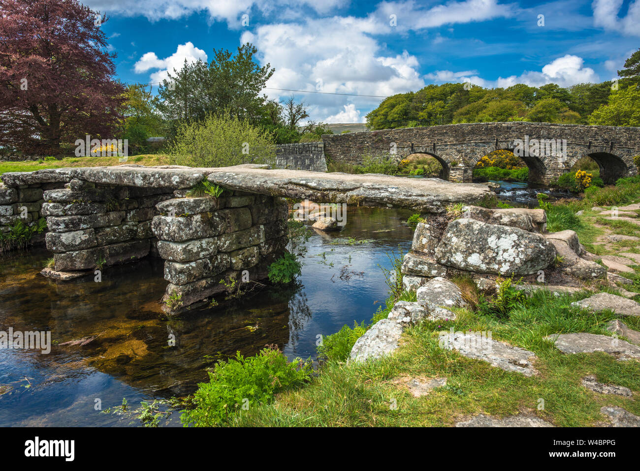 Medieval clapper bridge over the East Dart River at Postbridge on Dartmoor in Devon, West Country, England, UK Stock Photo