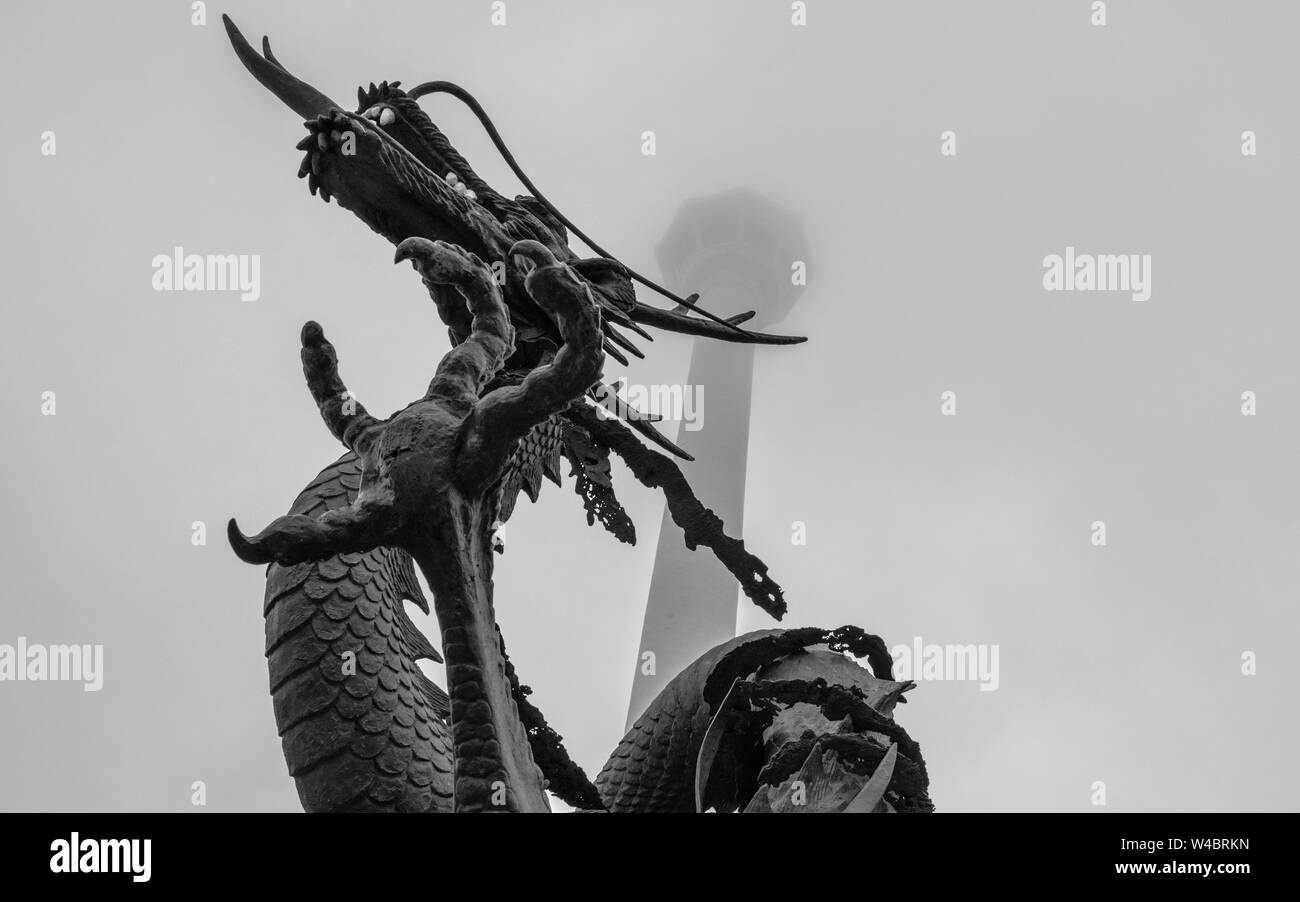 Busan Tower with korean Dragon Statue in front on a foggy day. Jung-gu, Busan, South Korea. Asia. Stock Photo