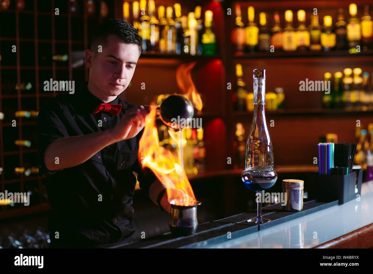 Bartender makes hot cocktail in a restaurant in the bar. Stock Photo