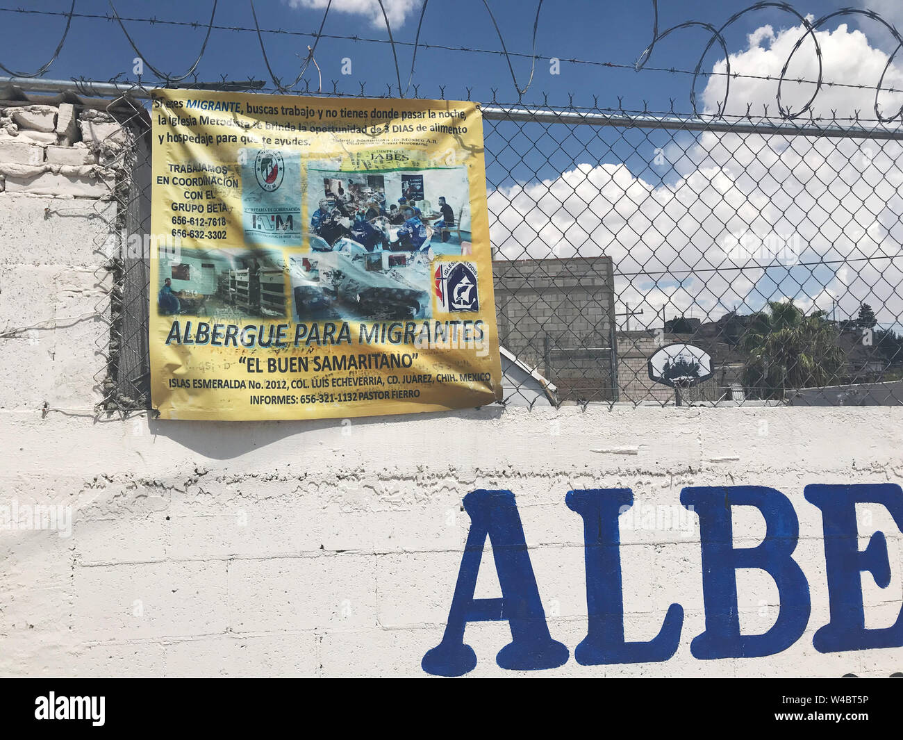 12 July 2019, Mexico, Ciudad Juárez: The fence around the El Buen Samaritano migrant hostel is secured with barbed wire. On the Mexican side of the border with the USA, thousands of people are waiting in hostels like this to emigrate to the USA. Dangers lurk in the border towns. Photo: Nick Kaiser/dpa Stock Photo