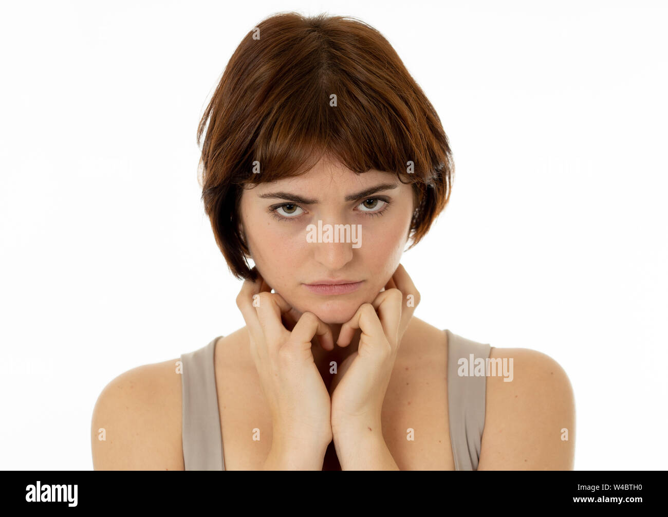 Close up of a young sad woman, serious and concerned, looking worried in emotional pain. Feeling sorrow and depression. Isolated in neutral background Stock Photo