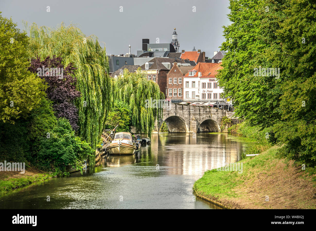 Roermond, the Netherlands, July 12, 2019: view along the meandering river  Roer towards 18th century Stone Bridge and the city center Stock Photo -  Alamy