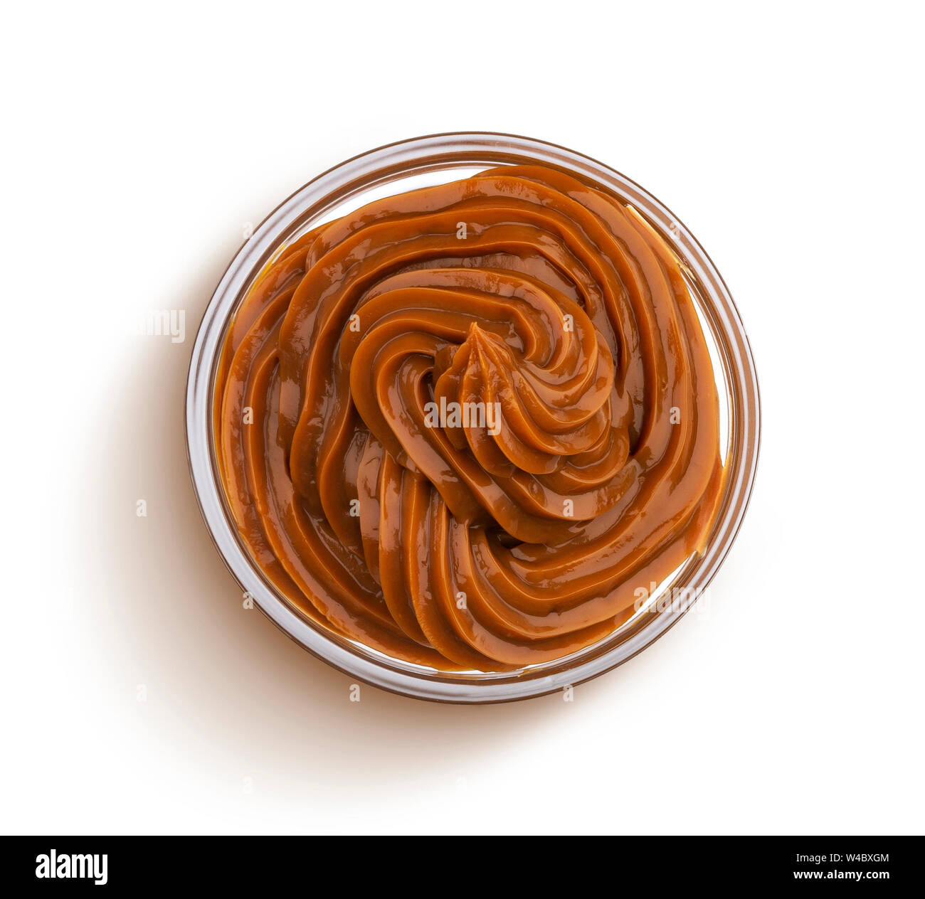 Swirl of melted caramel cream isolated on white background, boiled