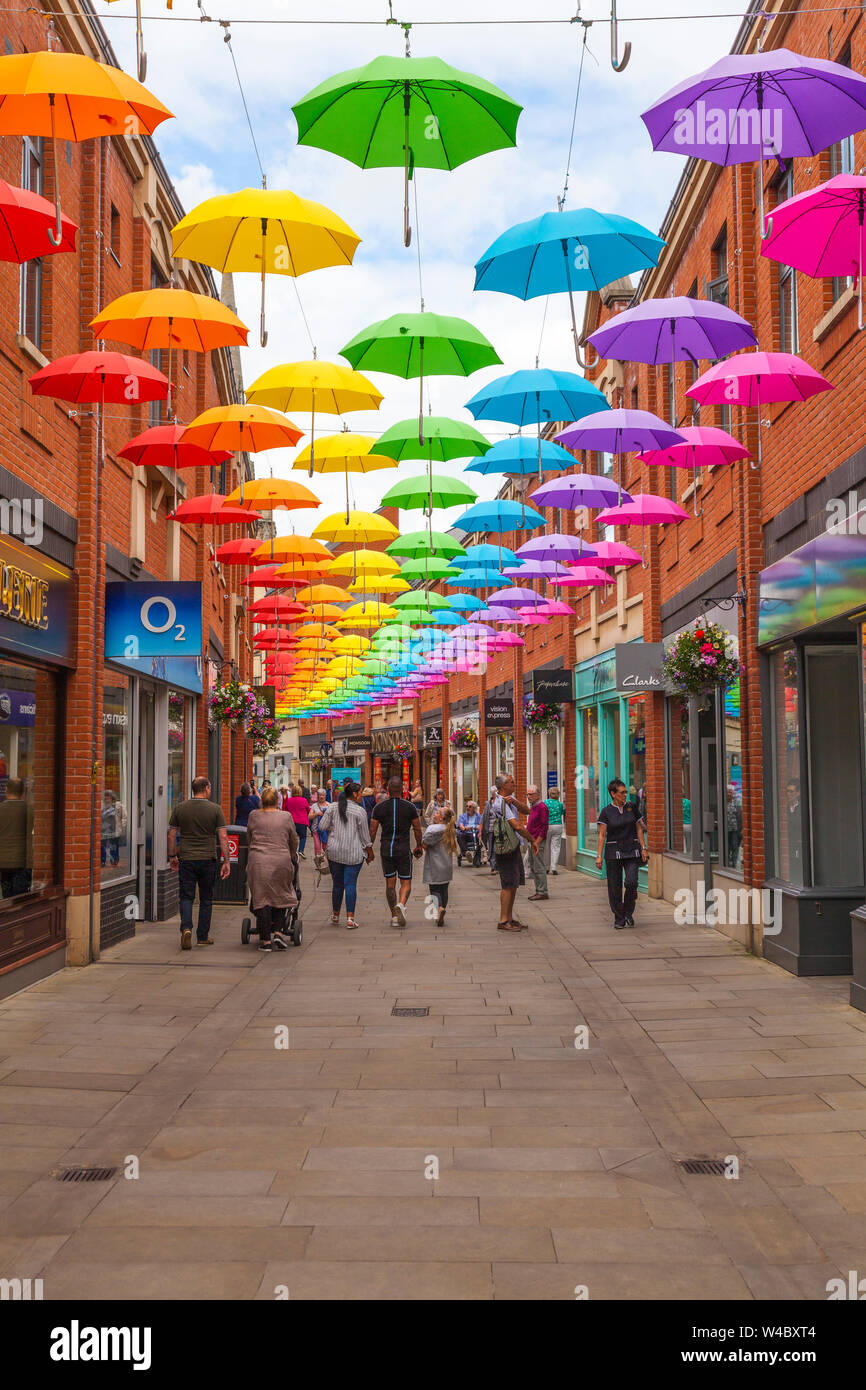 A colourful display of umbrellas hanging overhead in the Prince shopping precinct in