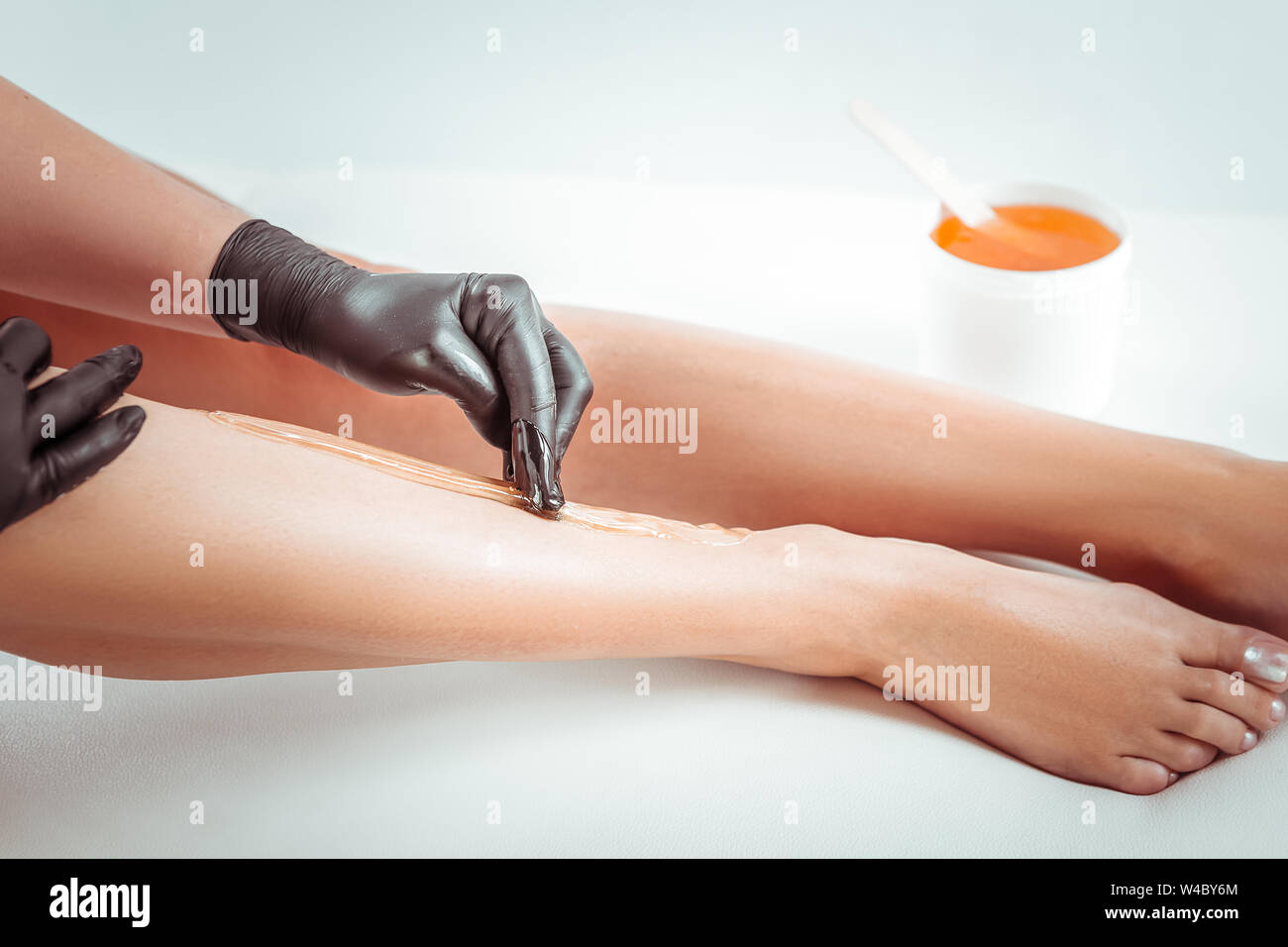 Diligent depilation expert going through depilation session Stock Photo