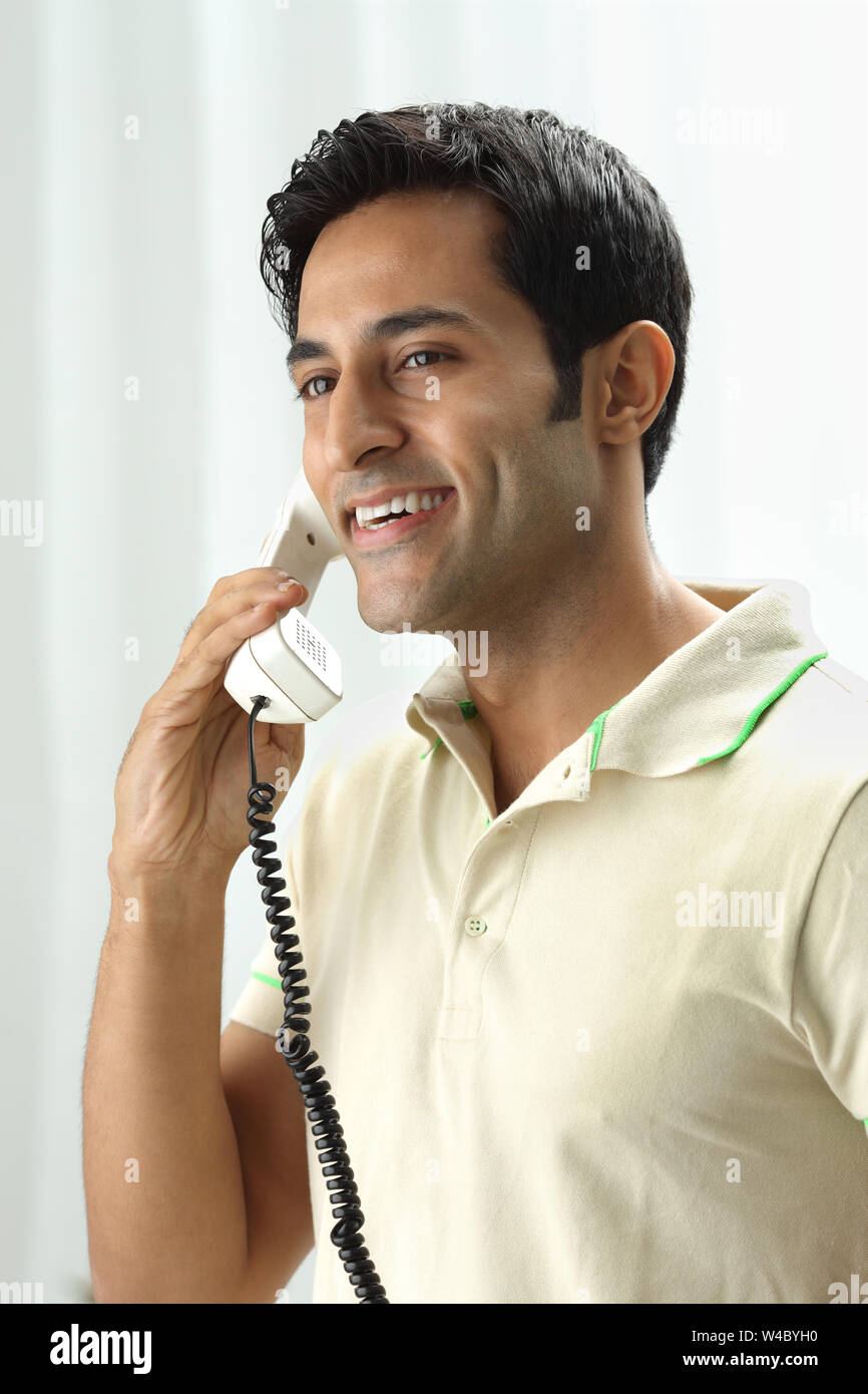 Standing Smiling Looking Away Holding Landline Phone Communication standing-smiling-looking-away-holding-landline-phone-communication