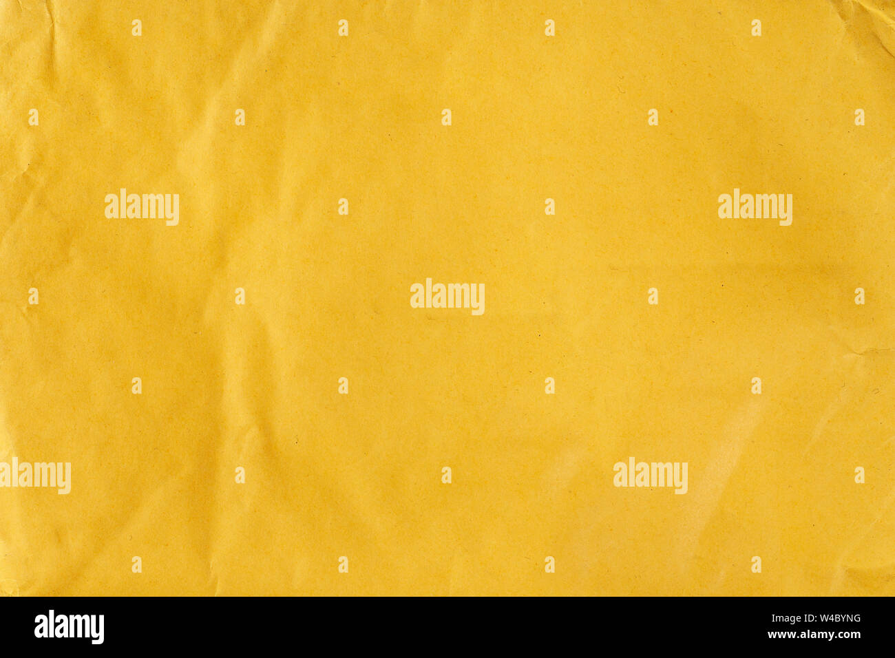 yellow sheet of paper abstract background. the sheet is slightly dented