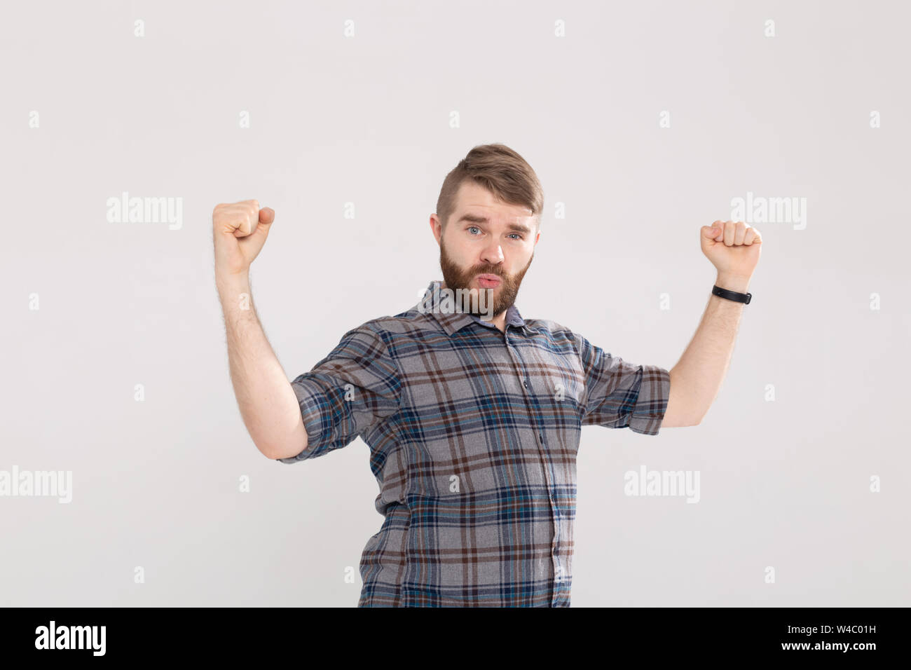 People, emotions and victory concept - Funny young man dressed in shirt ...