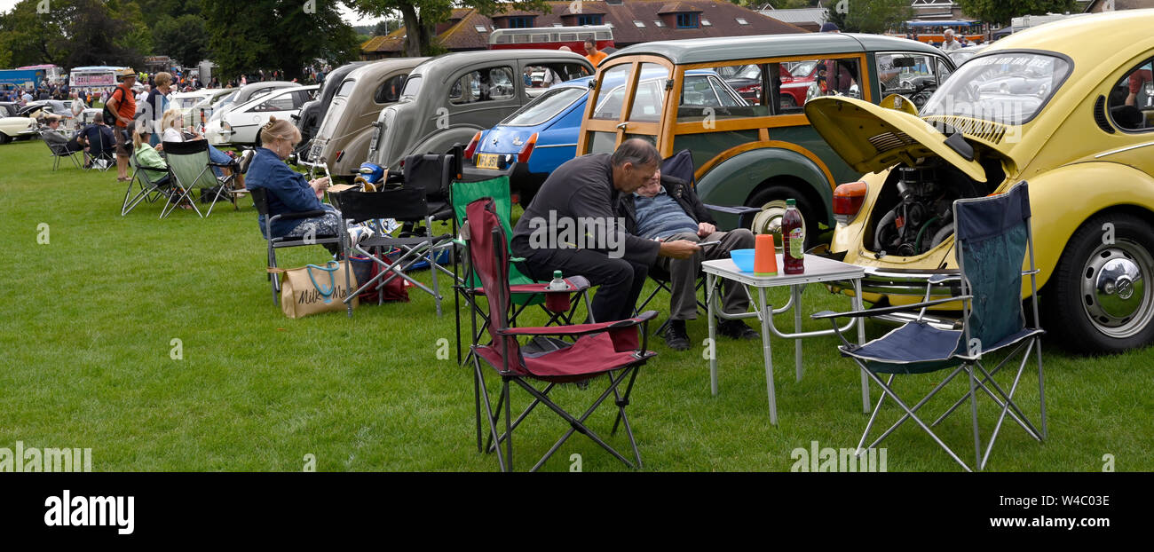 Enthusiasts picnicking at a vintage car show. Stock Photo