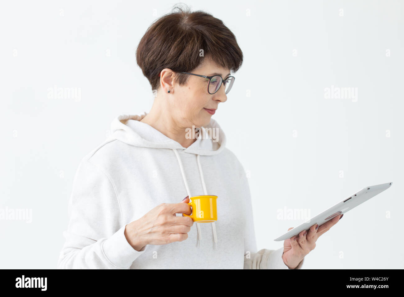 Beautiful Woman 50 Years Old With Short Hair Holding Tablet And