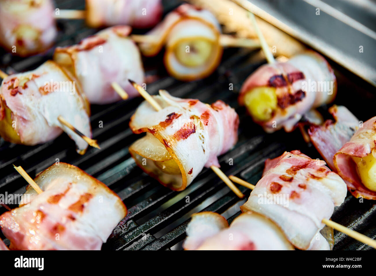 Grilled potato with bacon on gas grill . Grilled food. Barbecue. Copy space. Healthy food Stock