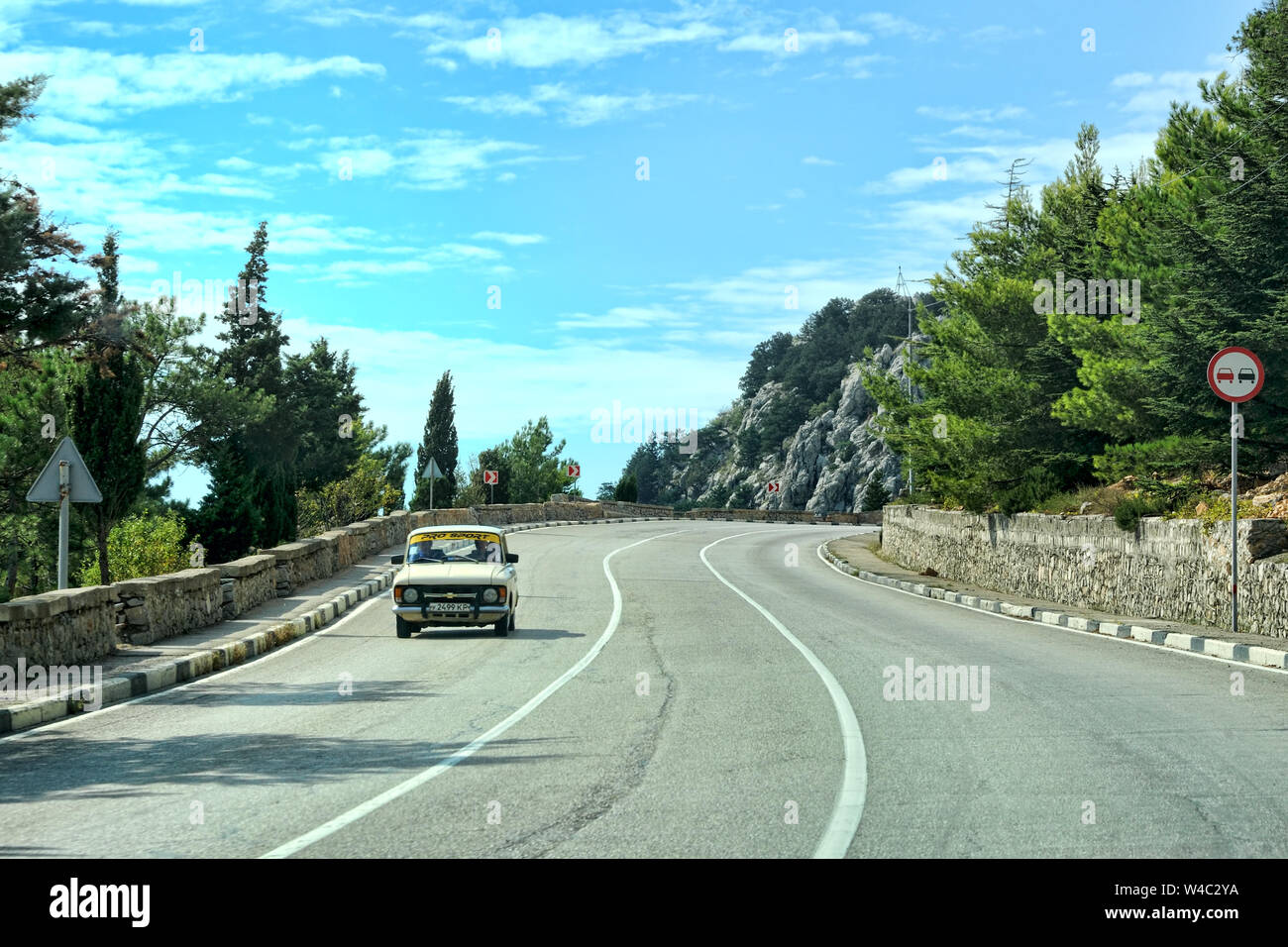The Old Soviet Car on a Curve of South Coast Highway Stock Photo