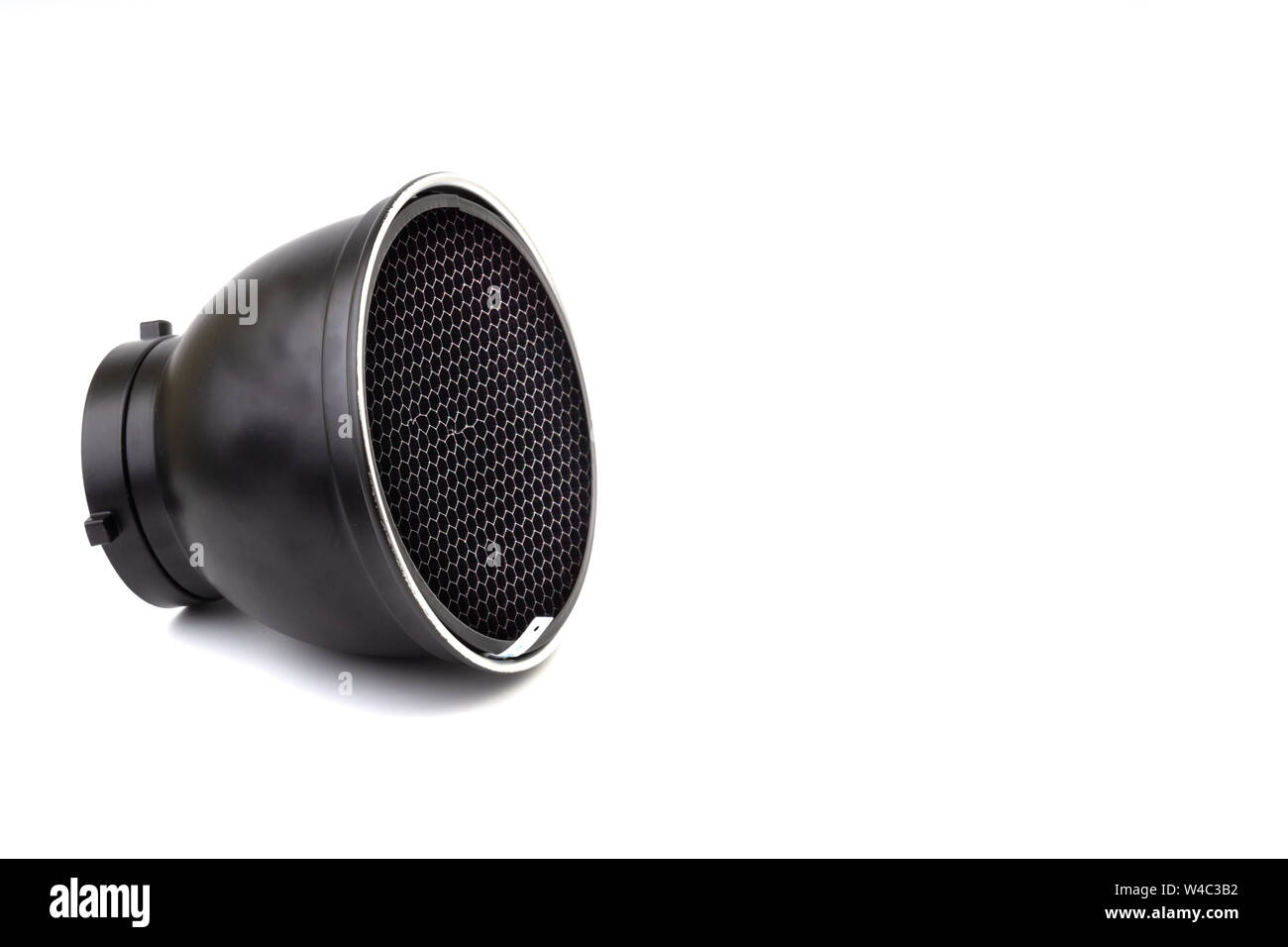 Reflector with honeycomb grid accessory for studio strobes and flashes on white background. Selective focus Stock Photo