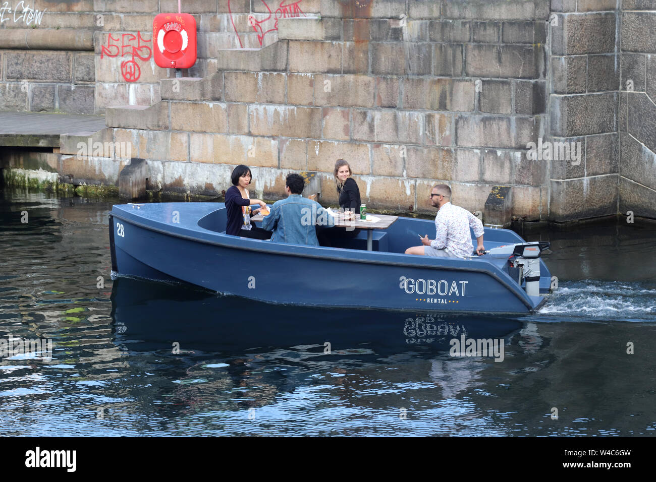 Tourist and friends enjoying the views of the city of Copenhagen on a GoBoat  rental tour Stock Photo - Alamy