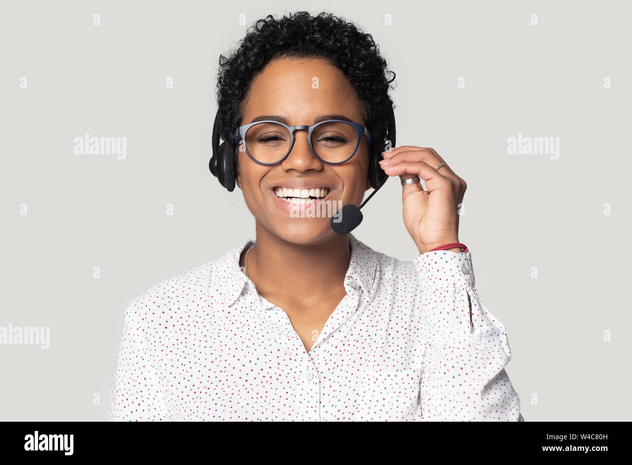 Portrait of smiling biracial female call center agent in headset Stock Photo