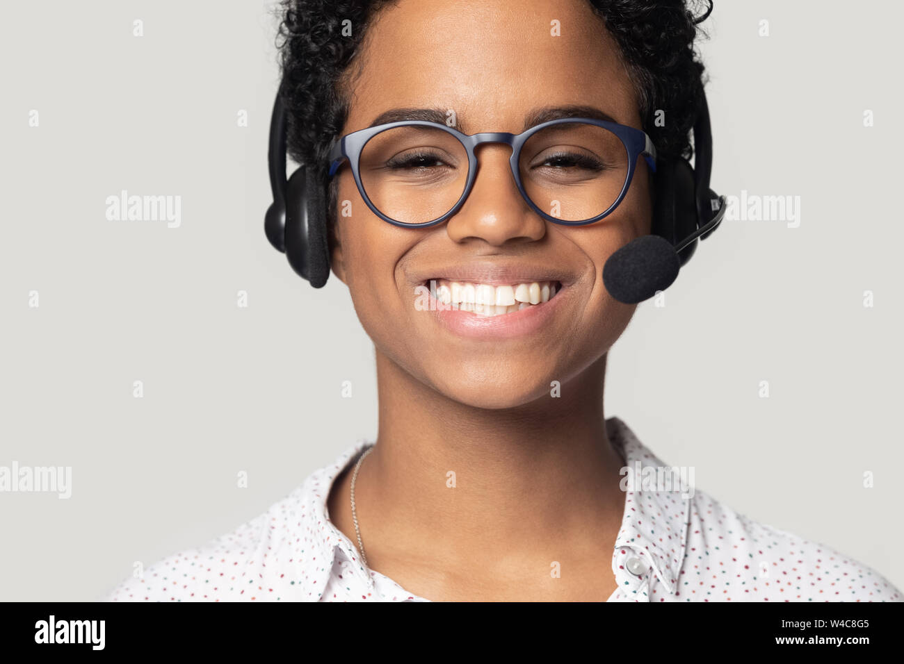 Close up portrait of happy biracial female call center agent Stock Photo