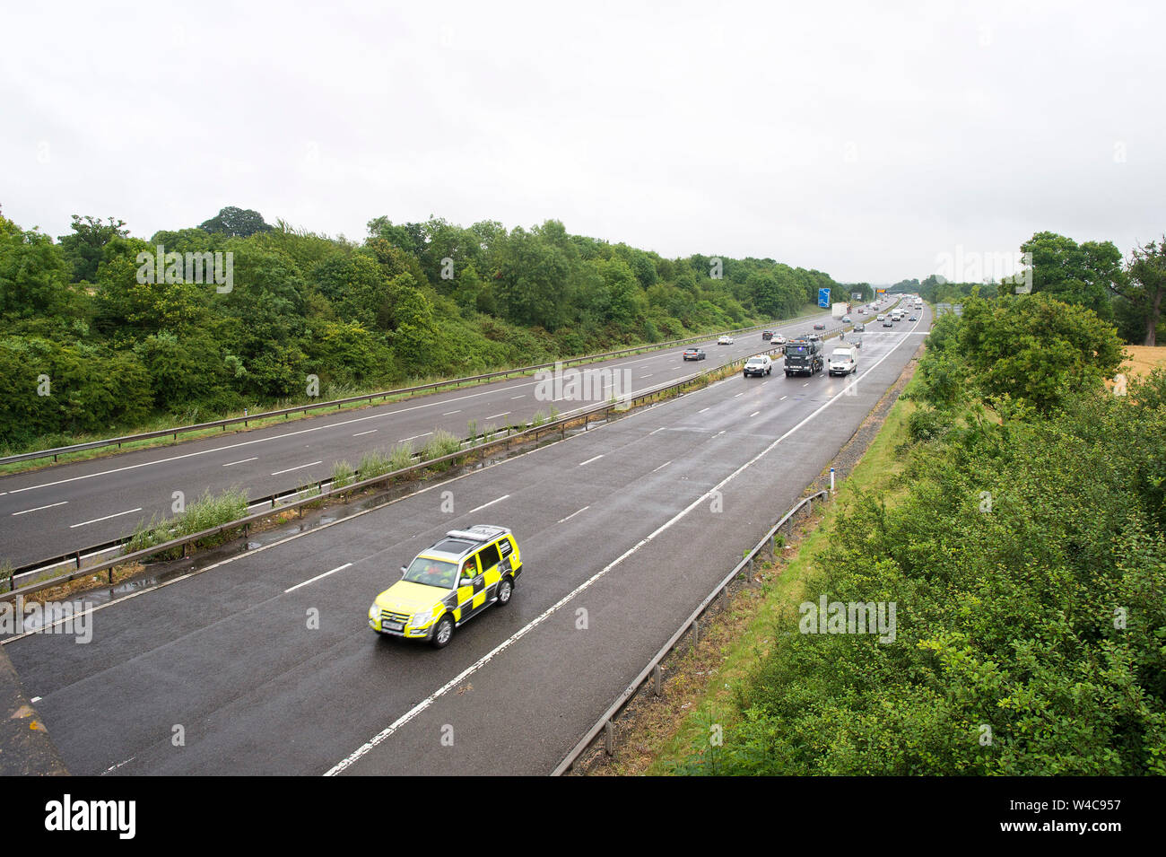 Motorway Traffic follows an emergency vehicle after the M40 near Warwick was closed due to a lorry fire. 19 July 2019. Stock Photo